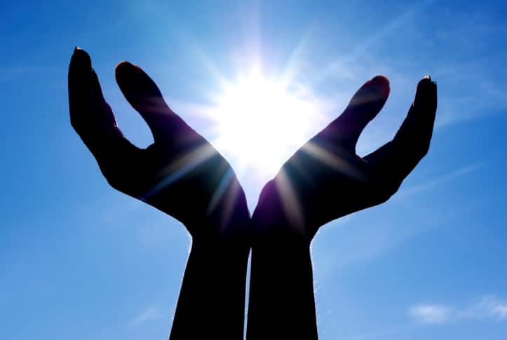A pair of hands against the sun