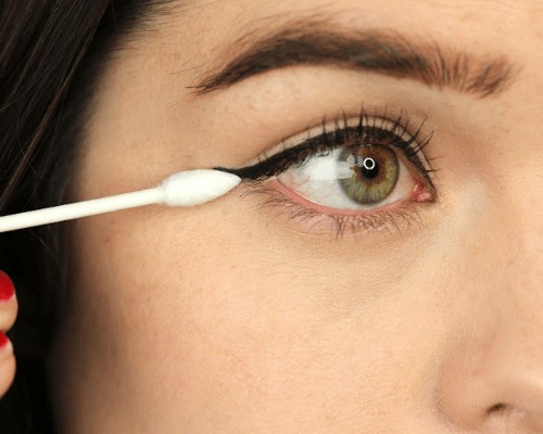eyeliner using a cotton  bud