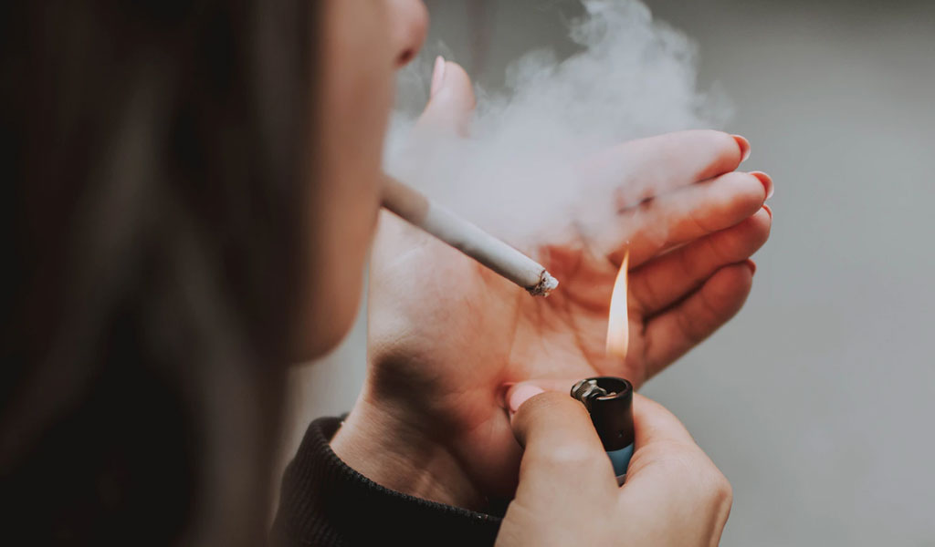 woman lights her cigarette with lighter