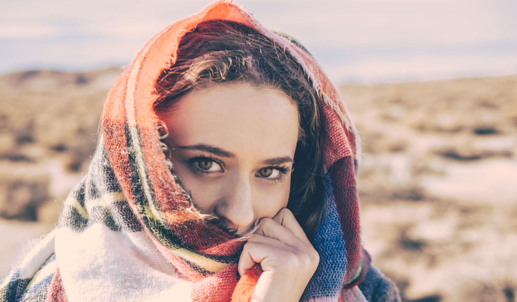 women covering her face with scarf 