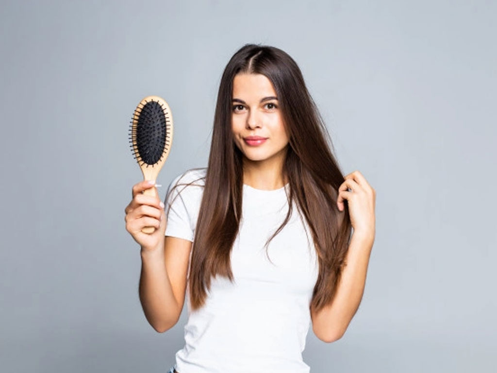 Woman combing her hair 