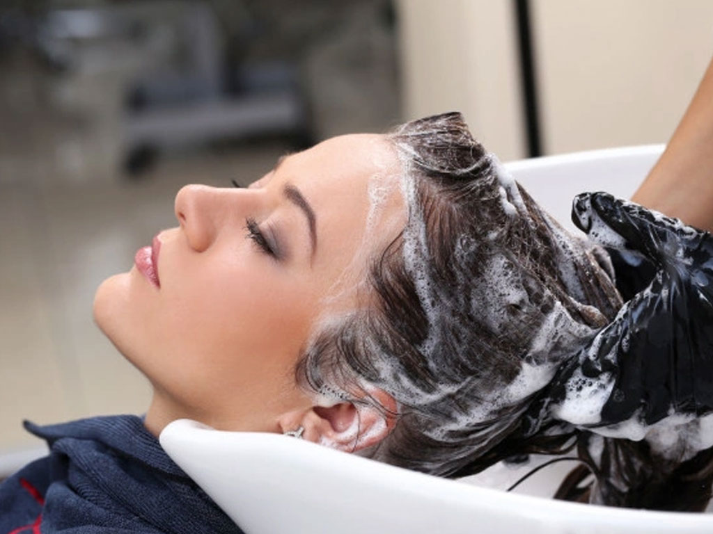 woman washing hair with shampoo