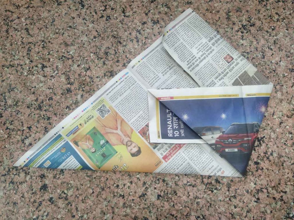 अखबार को ऊपर की तरफ मोड़ दें
