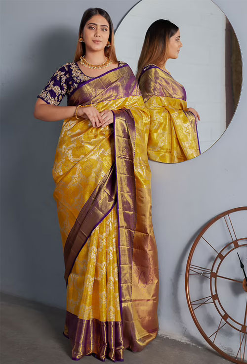 Yellow Zari woven Kanjeevaram Saree With Blue And Gold Border