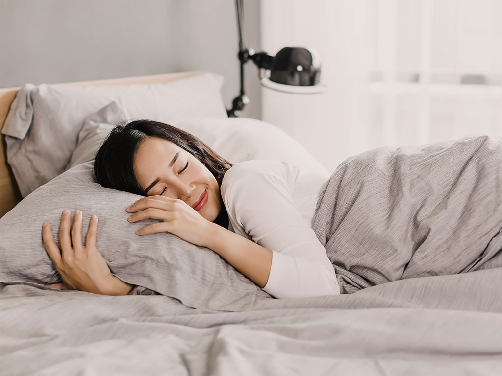 A Women Sleeping On Bed