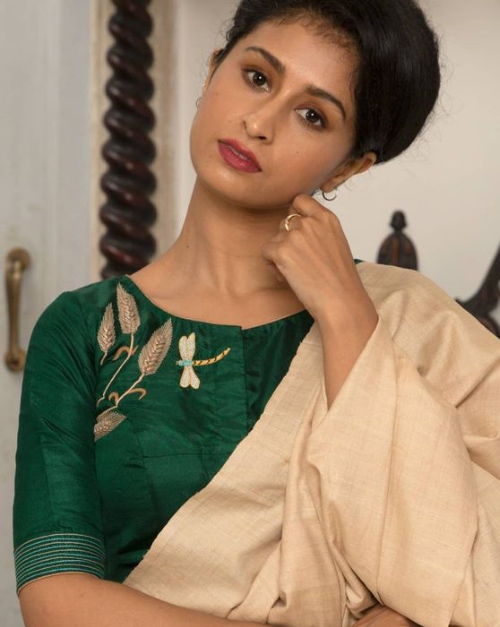 Cream Color Saree And Dark Green Blouse